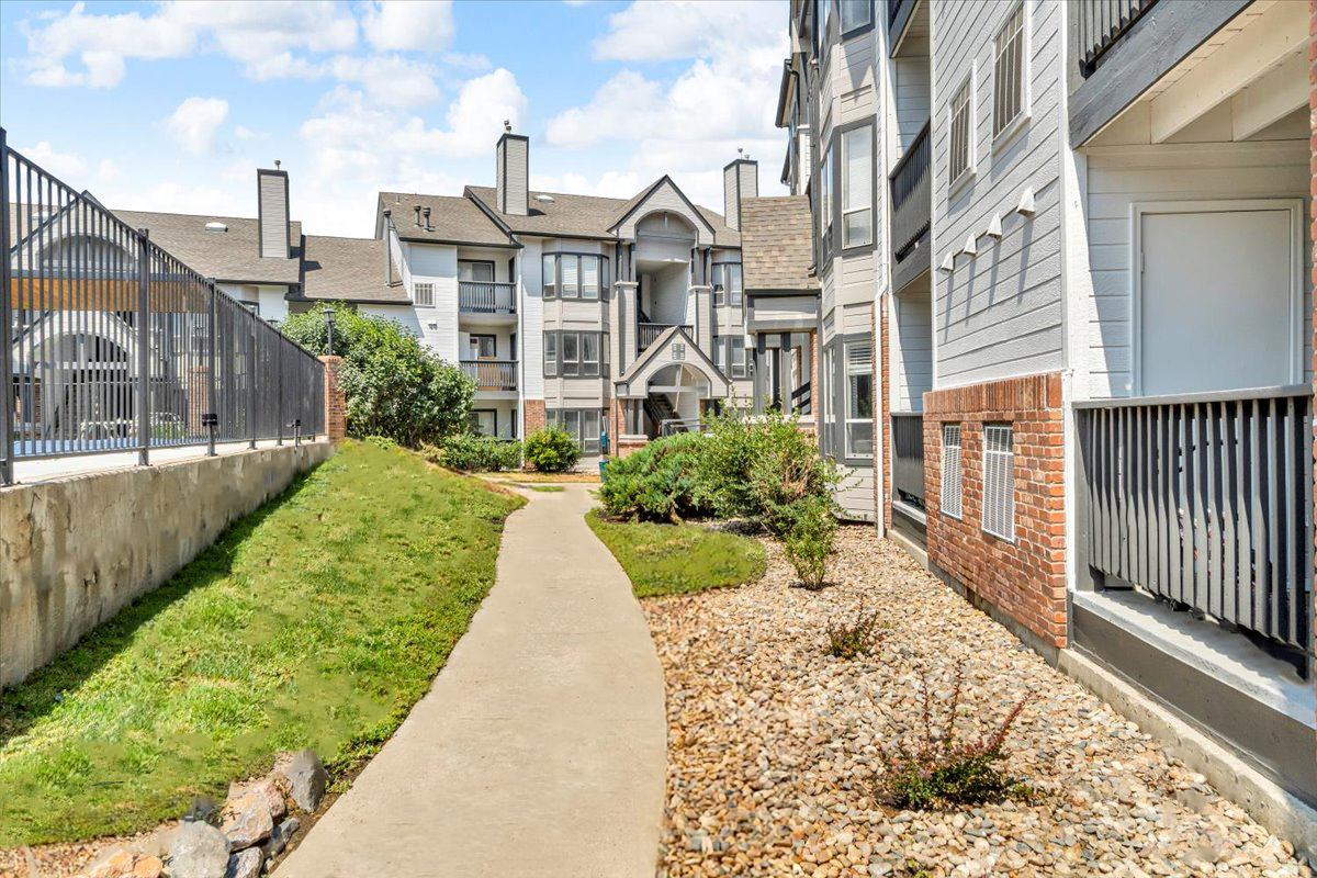the walkway to the apartment complex at The Residences at Bear Creek