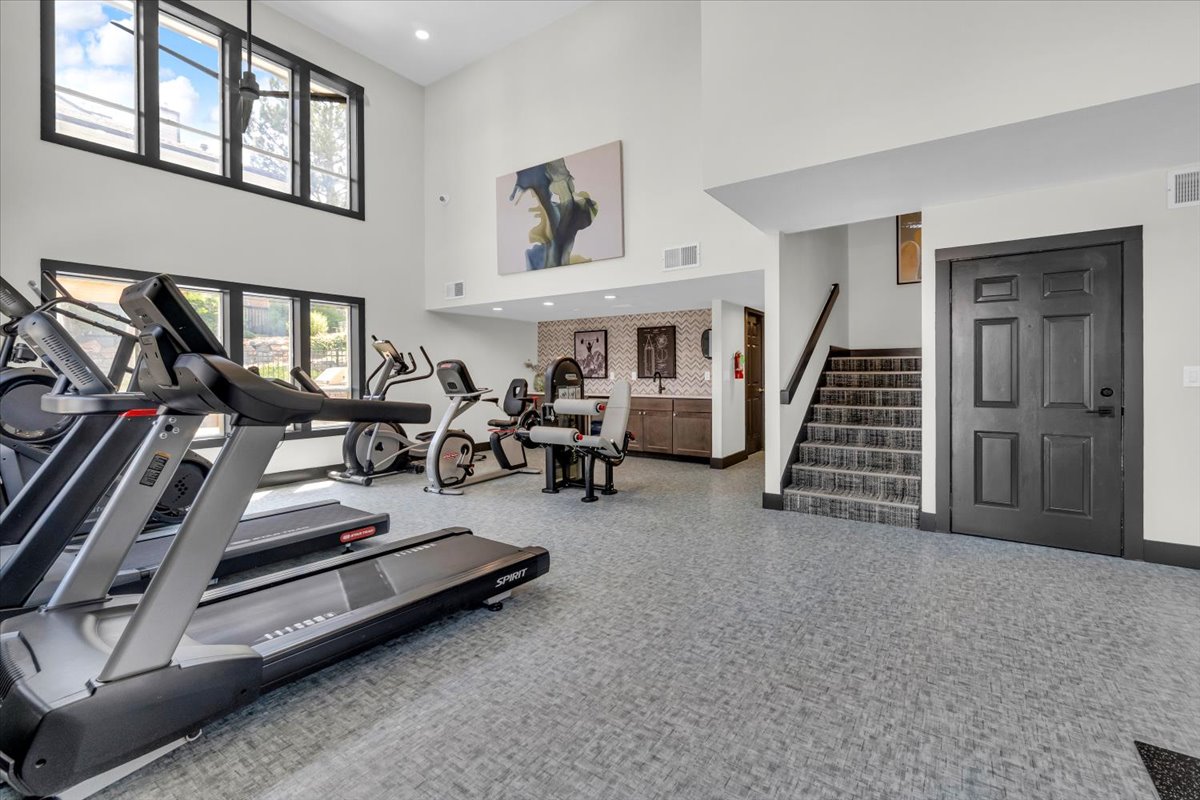 a gym with treadmills and exercise equipment at The Residences at Bear Creek