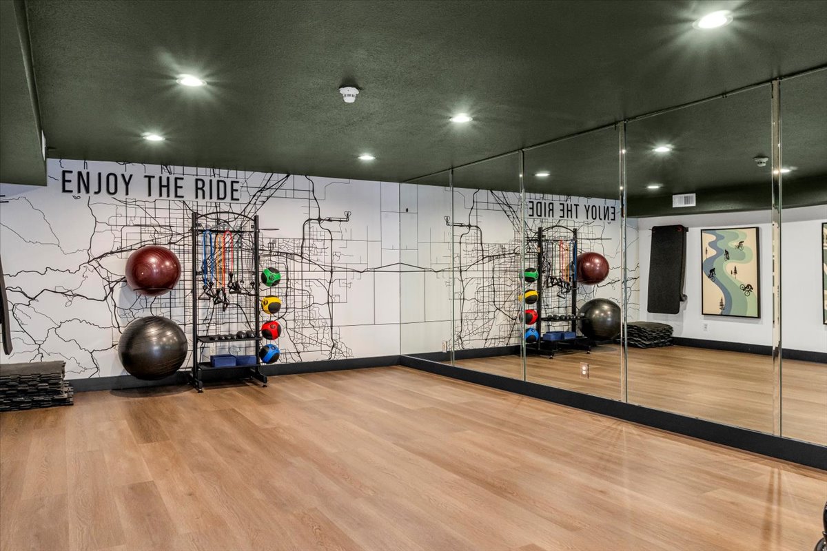 a gym room with mirrors and exercise equipment at The Residences at Bear Creek