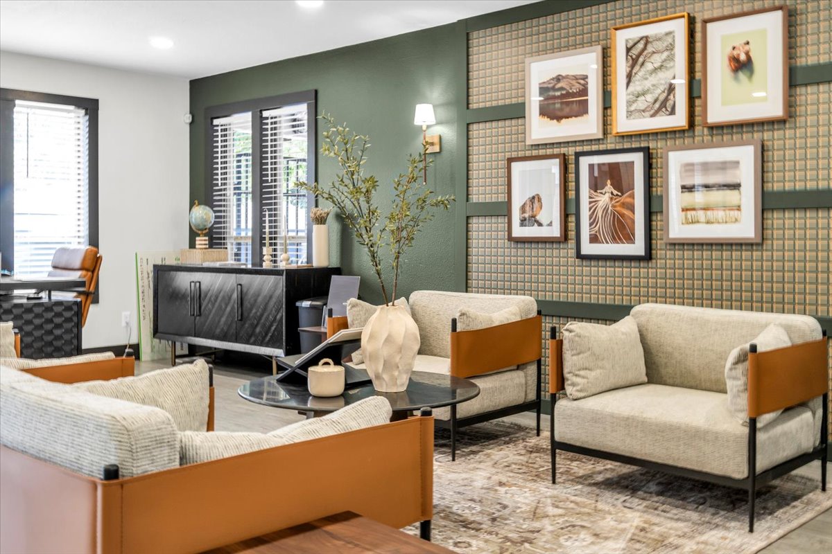 the living room features a large picture frame and a couch at The Residences at Bear Creek