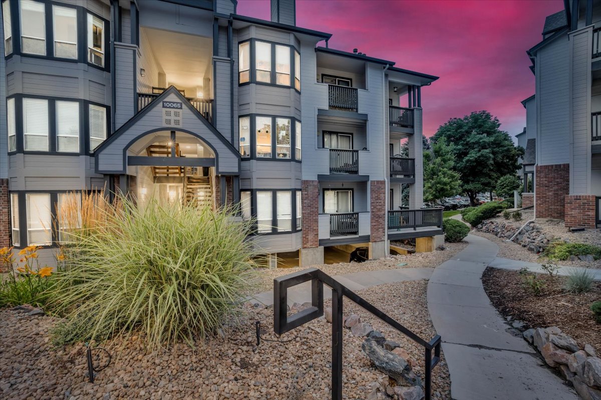the exterior of an apartment building at dusk at The Residences at Bear Creek